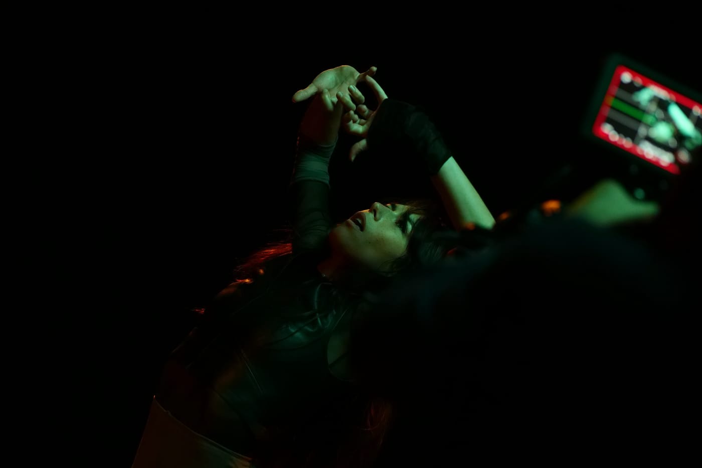 Veronica Lillo performing under green light