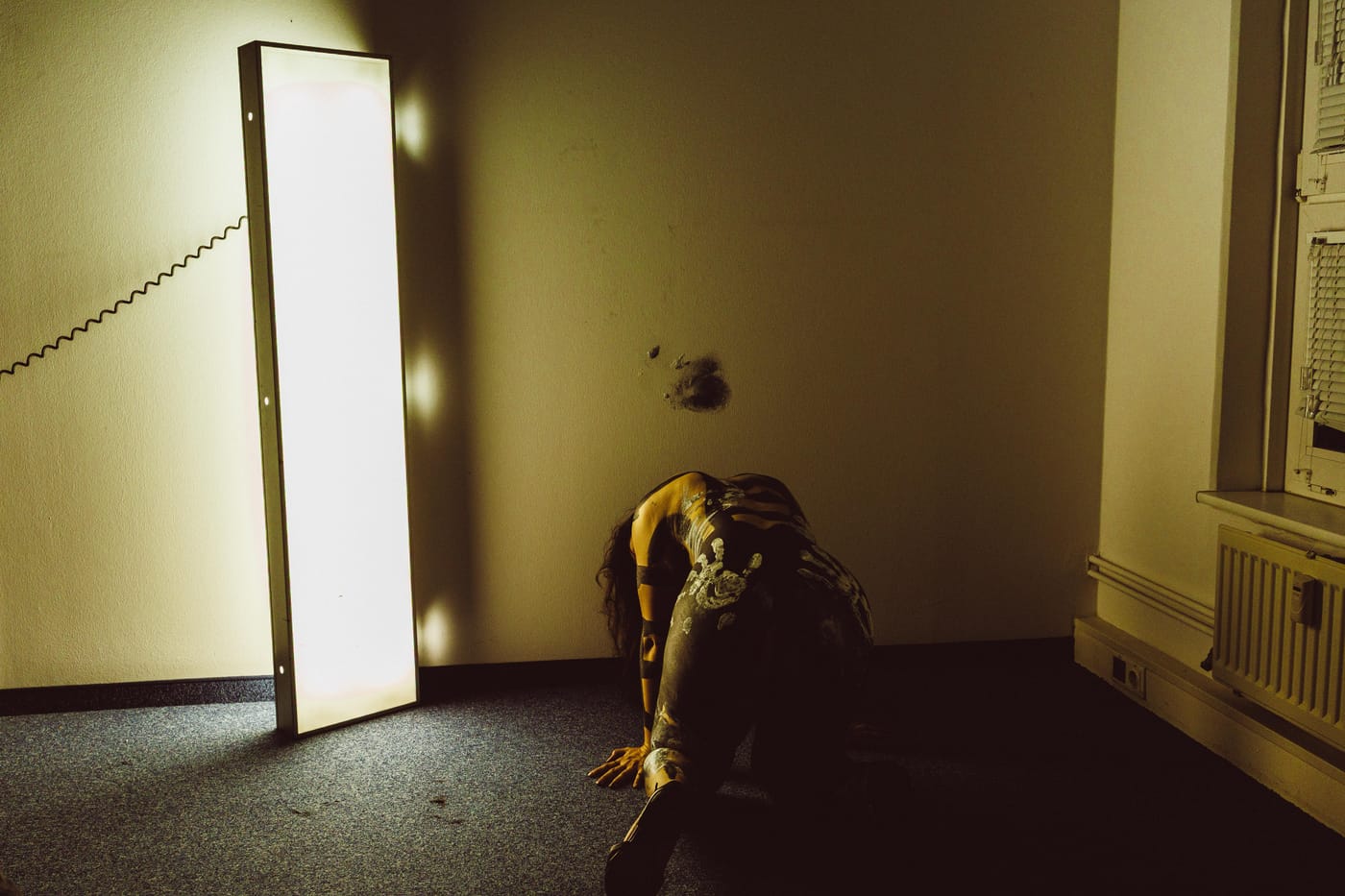 Figure at the far end of a bright corridor