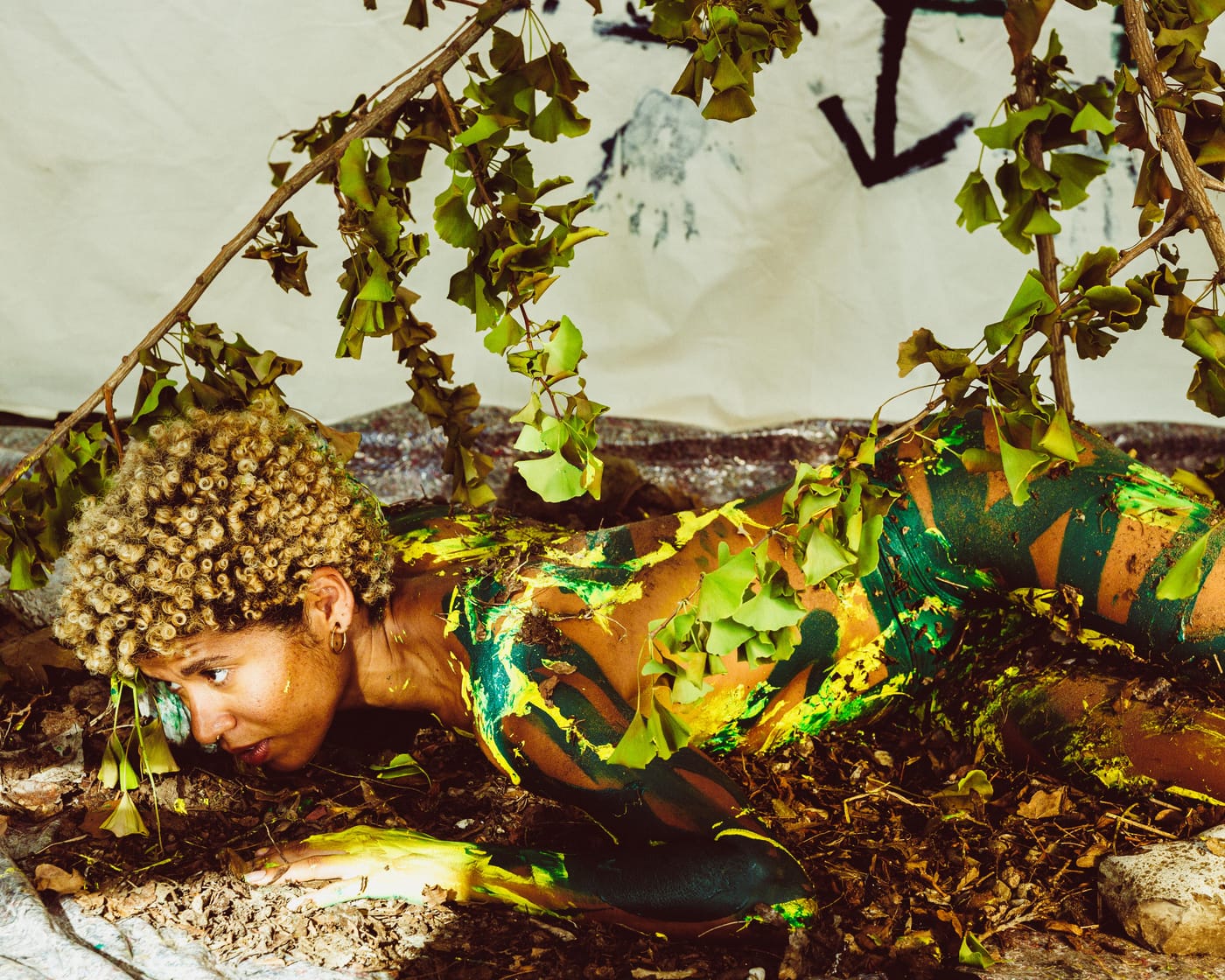 Body lying among dried branches and foliage