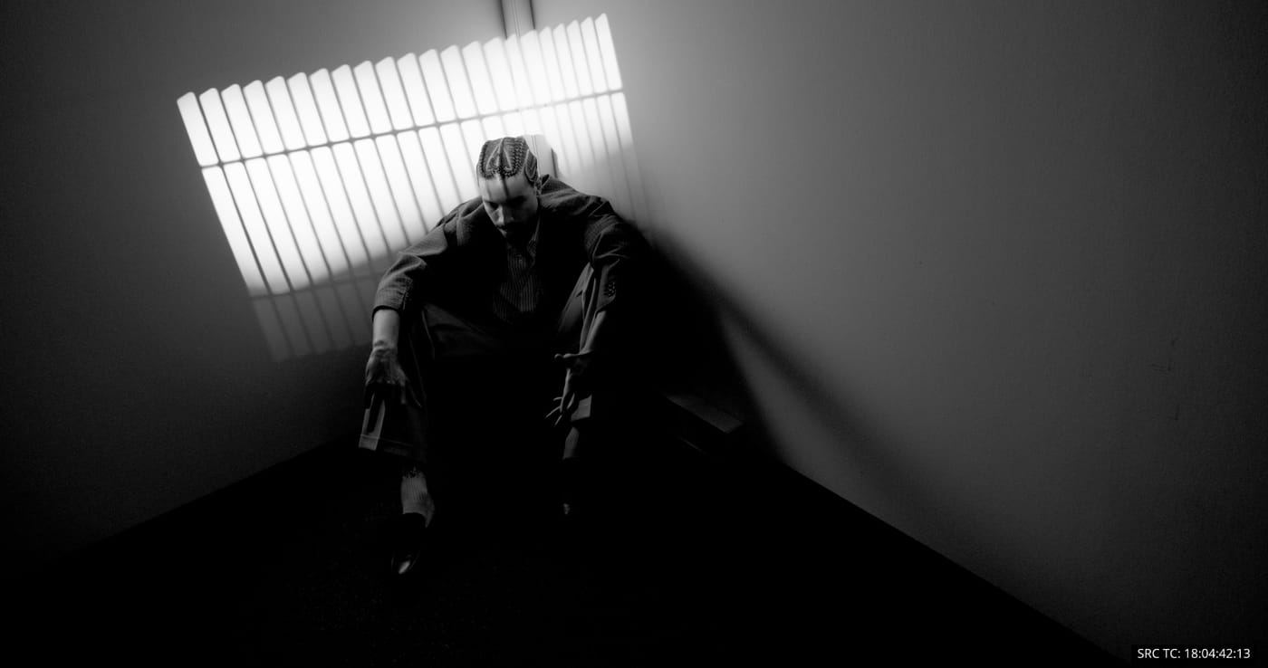 A figure stretching in a low-lit room