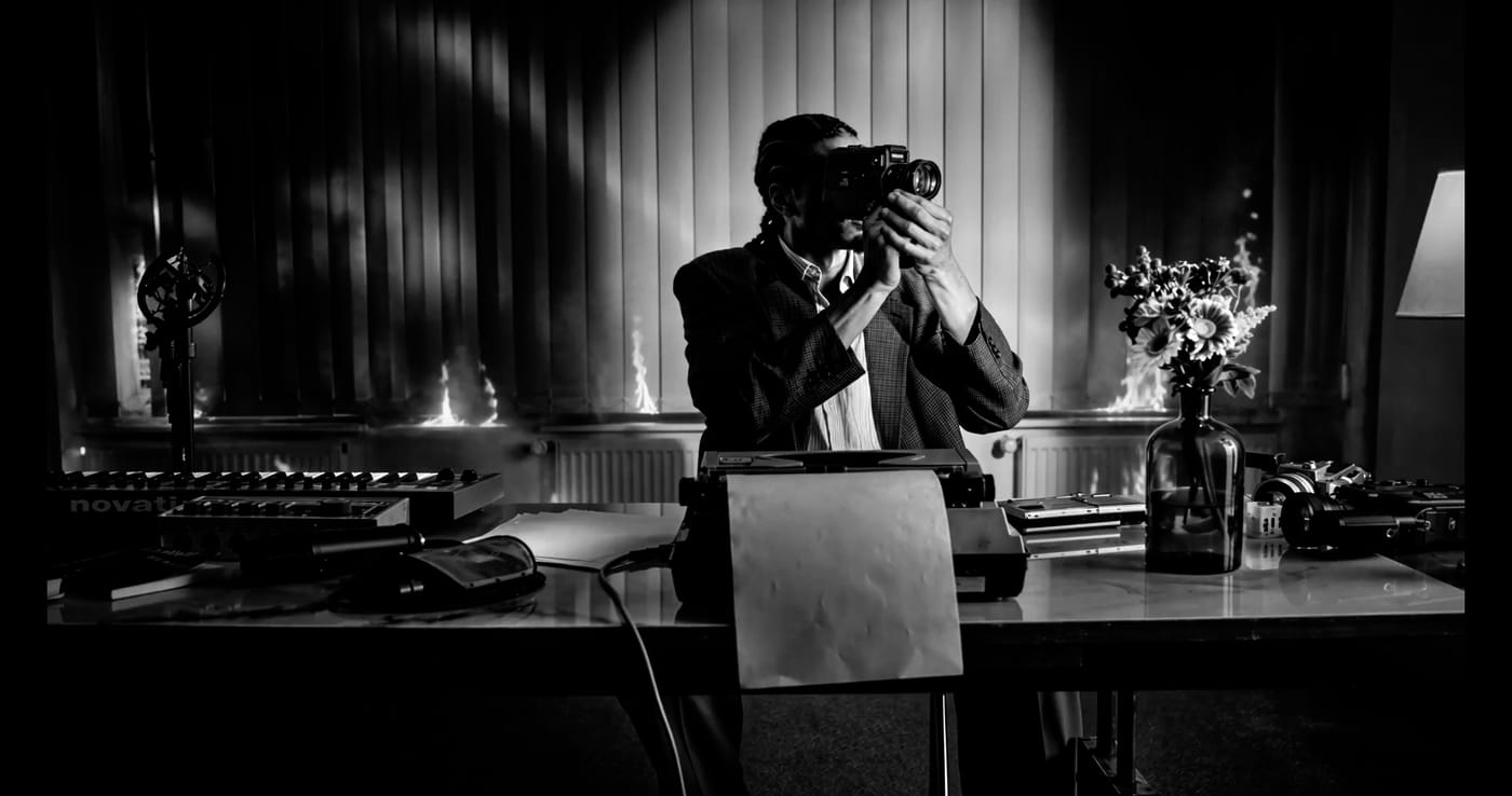 Figure in a hat seen through an office doorway