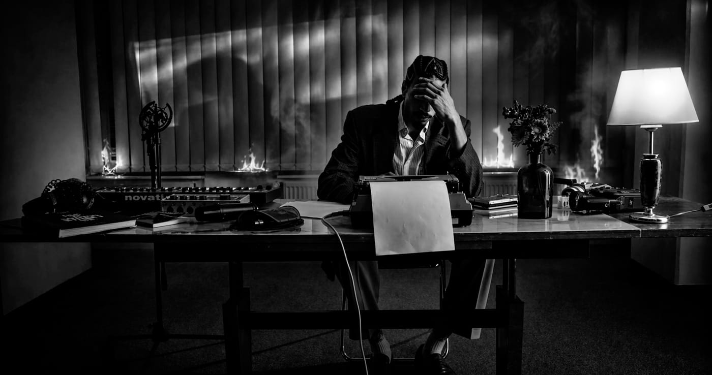 A figure at a desk in a dark interior